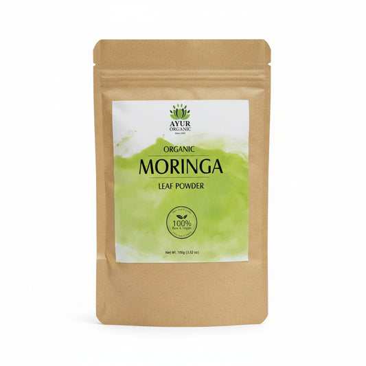 Moringa powder package on a cardboard surface