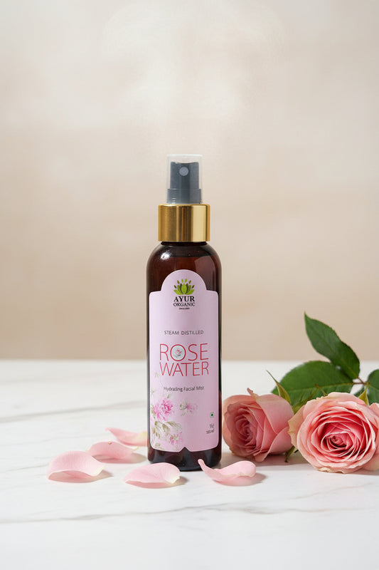 Rose water spray bottle with a brand label on a surface